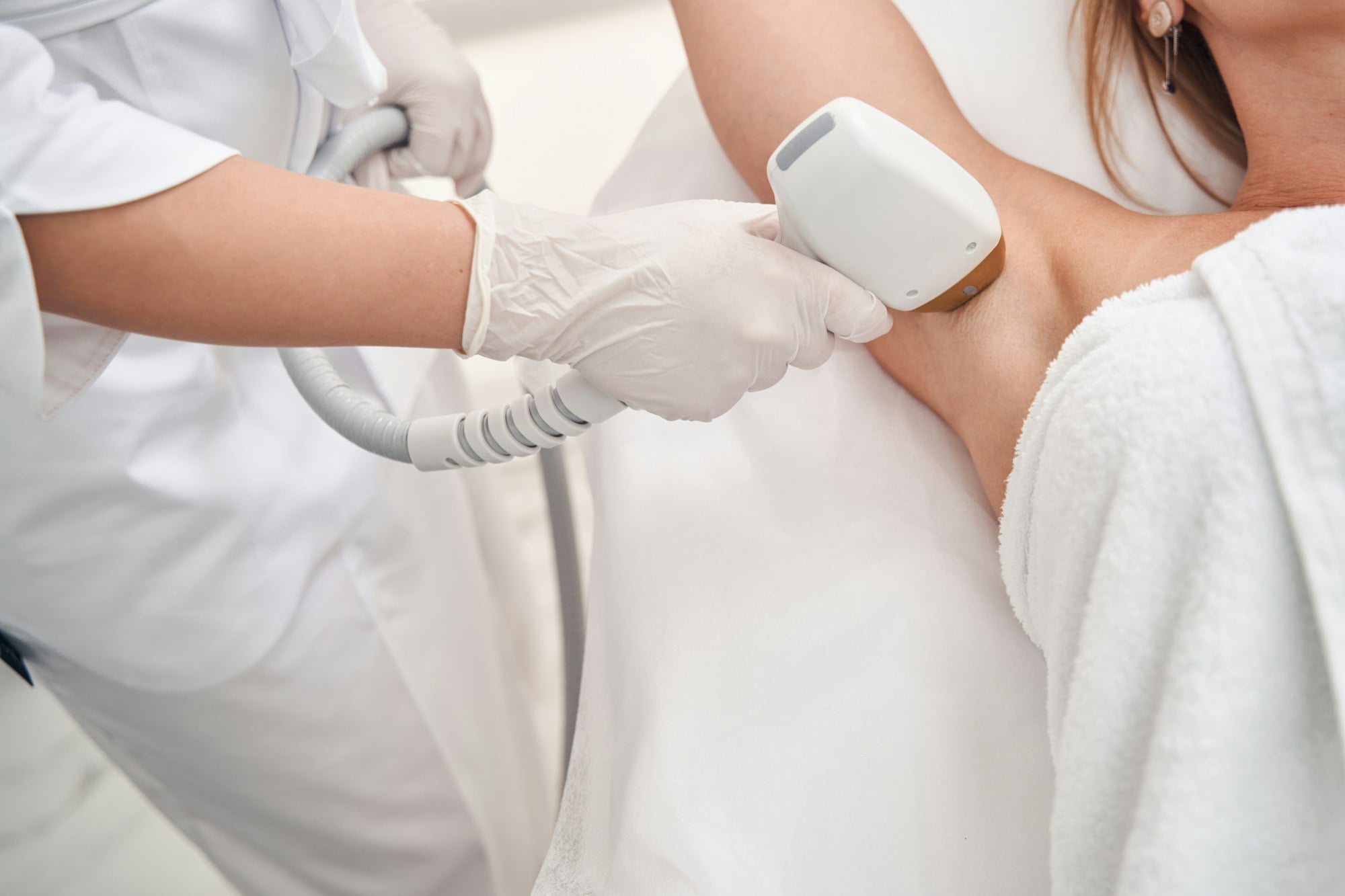 Woman coming to cosmetologist for laser epilation
