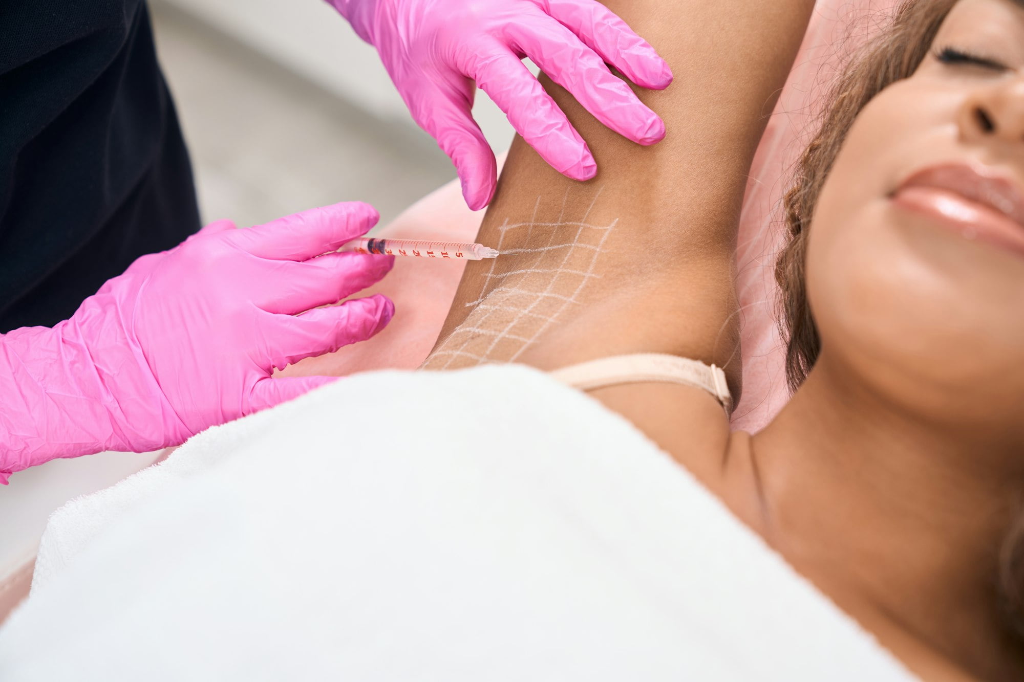 Young patient receives injections in the armpit area